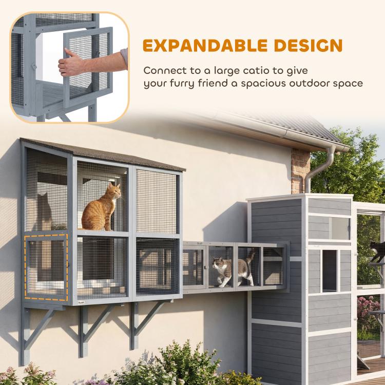 Gray multi-section outdoor cat enclosure with mesh doors and cats on platforms
