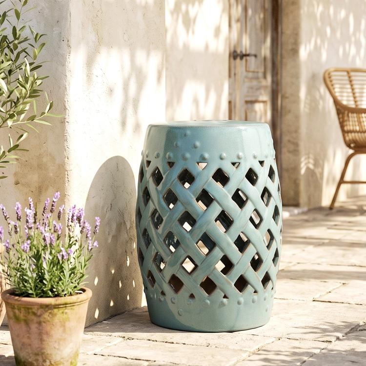 Ceramic garden stool with teal glazed finish and cutout lattice pattern