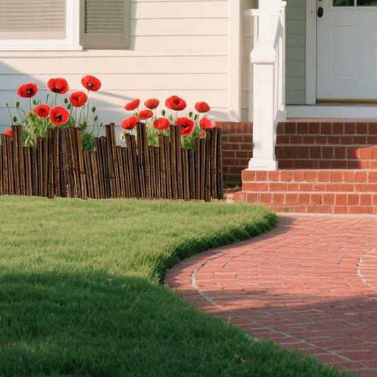 Outdoor bamboo fence edging with upright poles along a garden path