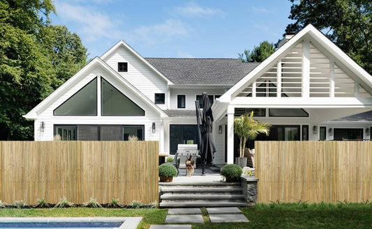 Natural bamboo privacy fence panels installed around a front yard walkway