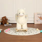 White plush alpaca rocker toy with wooden base and black-dot play mat