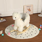 White plush alpaca rocking toy seated with wooden rocker base