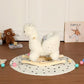 White plush alpaca rocking toy showing curled tail and wooden base