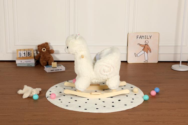 White plush alpaca rocking toy showing curled tail and wooden base