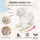 White plush rocking alpaca toy with built-in jingle sound and wooden base