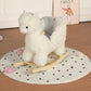 White plush alpaca rocking horse toy with wooden curved rockers and plush tail
