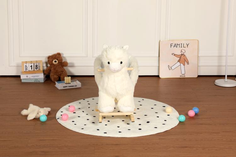 White plush alpaca rocking ride-on toy standing on wooden base on dotted mat