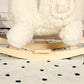 Close-up of white plush alpaca ride-on toy feet on wooden rocking base