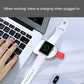 White magnetic wireless charging dock with red strap charging Apple Watch
