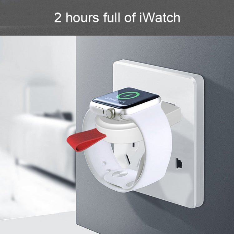 White magnetic charging dock plugged into wall outlet with Apple Watch on top