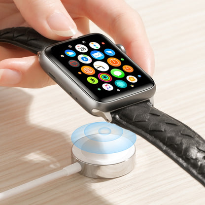 Magnetic charging cable with white puck and black braided strap housing