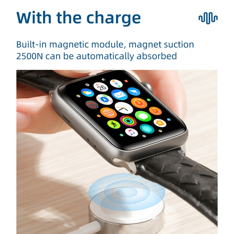 Magnetic charging puck connected to Apple Watch with visible charging cable