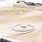 Coiled white magnetic charging cable with USB connector, smooth anti-knot design