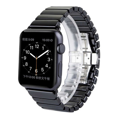 Black ceramic link Apple Watch band with metal clasp and visible smartwatch face