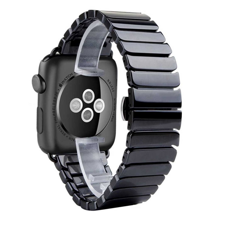 Black ceramic Apple Watch band close-up showing matte links and aluminum hardware