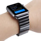 Black ceramic Apple Watch band worn on wrist with metal link clasp