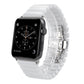 White ceramic link Apple Watch band with metal clasp and visible smartwatch face