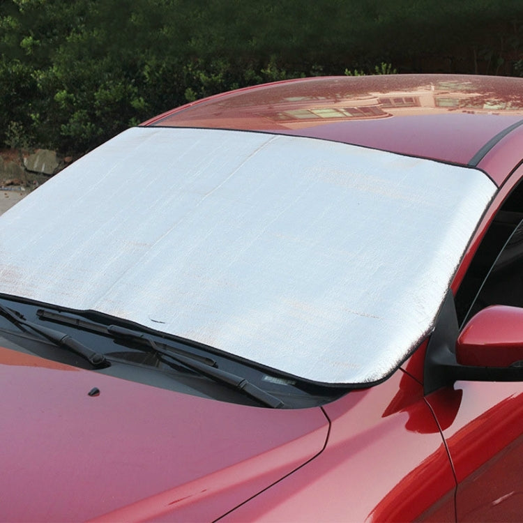 Car windshield sun visor, silver reflective panel with black trim and curved edge