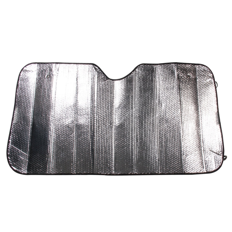 Folded car sun visor, silver reflective material with curved shape and black outline