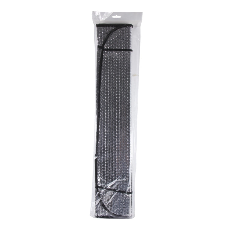 Packaged car sun visor in clear plastic, dark textured reflective panel with black trim