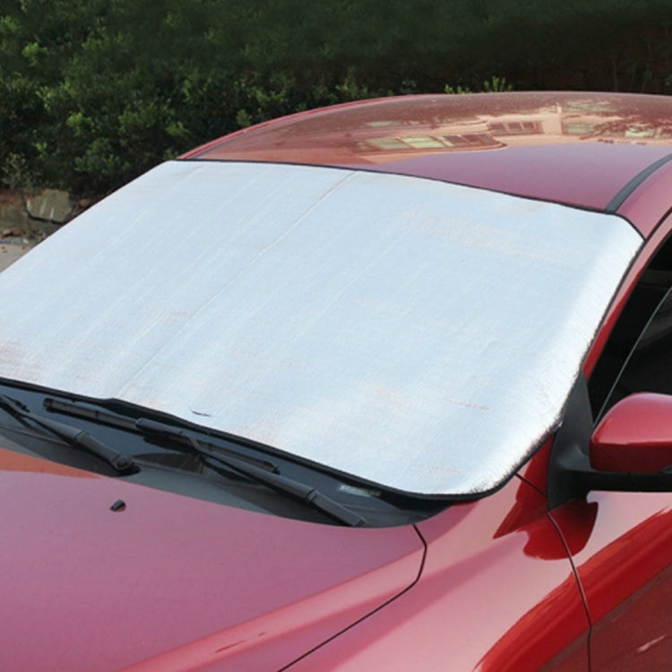 Car windshield sun visor, silver reflective panel with black trim and curved edge
