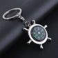 Silver compass wheel keychain with green-letter dial and attached split ring