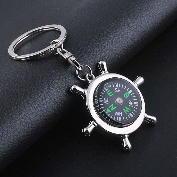Silver compass wheel keychain with green-letter dial and attached split ring