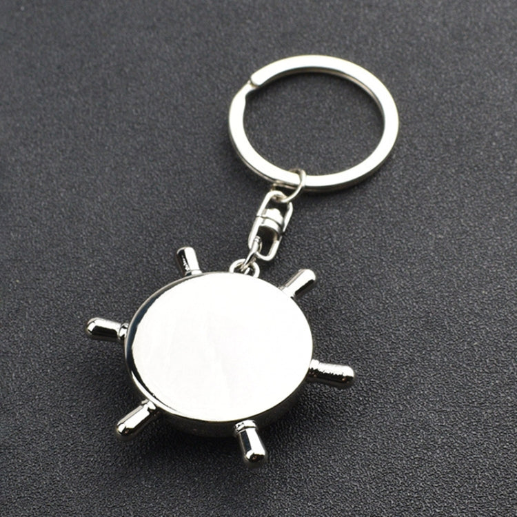 Silver compass-wheel keychain charm with key ring and four spokes, white face