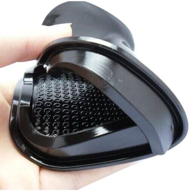 Black punctate phone slip mat close-up with textured grip surface and raised lip