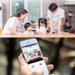 Wireless surveillance camera app on a smartphone shown in front of family indoors