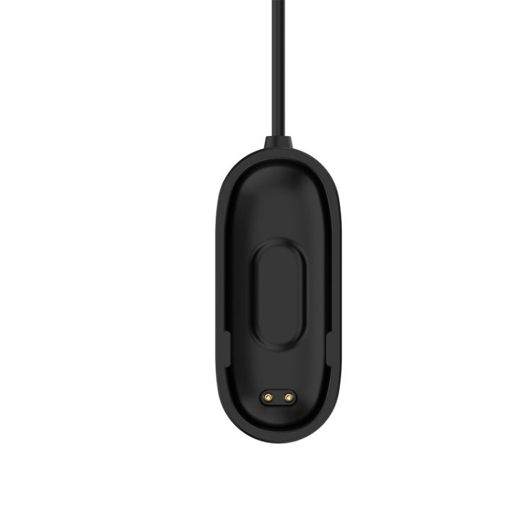 Black oval charging cradle with contact pins on a charging cable
