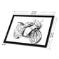 Black LED light pad with motorcycle line art and measurement markings on the panel