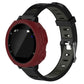 Red silicone protective watch case with cutouts and buttons, on black strap