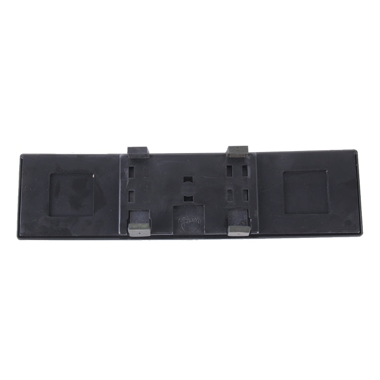 Back of interior rearview mirror with black plastic housing and mounting tabs
