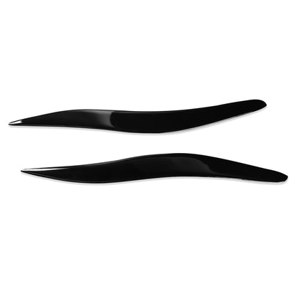 Black ABS headlight eyebrow trim pair, curved fitment pieces
