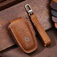 Brown leather key fob protective case with orange stitching and key ring clip