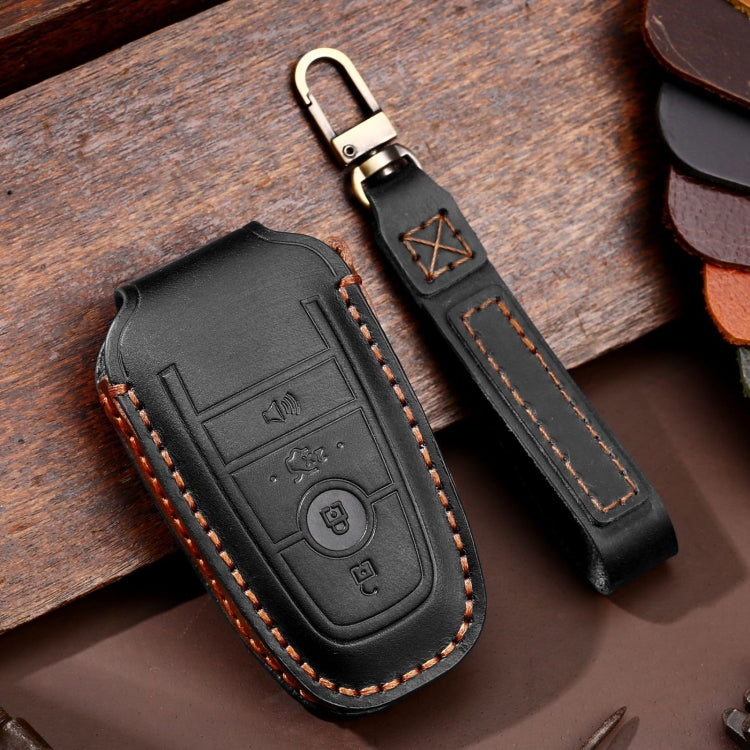 Black leather key fob protective case with key ring, embossed buttons, orange stitching