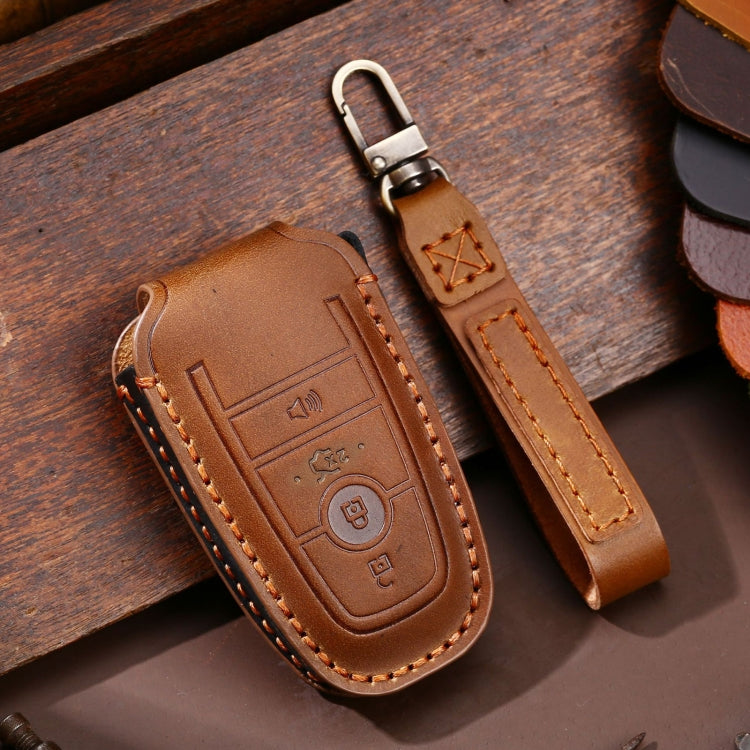 Brown leather key fob protective case with key ring, embossed buttons, orange stitching