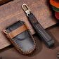 Leather car key cover with tan button panel, keyring loop, and contrast stitching