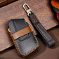 Black leather key fob case with brown stitched panel and snap-style cover