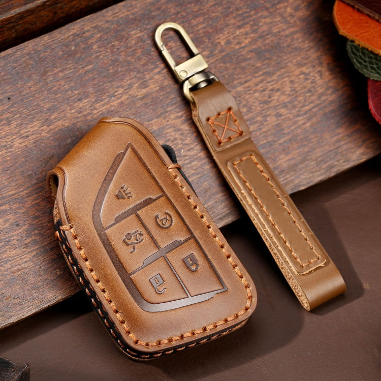 Brown leather car key protective case with tan stitching and embossed key button area