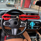 Red steering wheel anti-theft lock mounted across steering wheel with key in housing