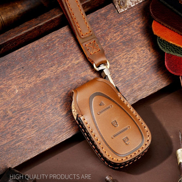 Tan/brown leather key fob cover close-up with stitched edge and key ring loop