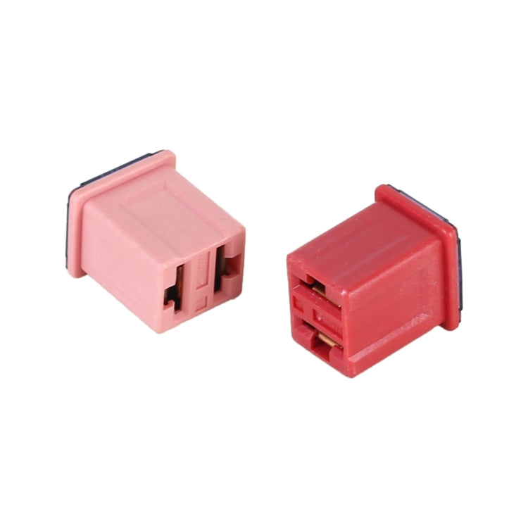 Close-up of two red and pink car blade fuses with metal connector tabs