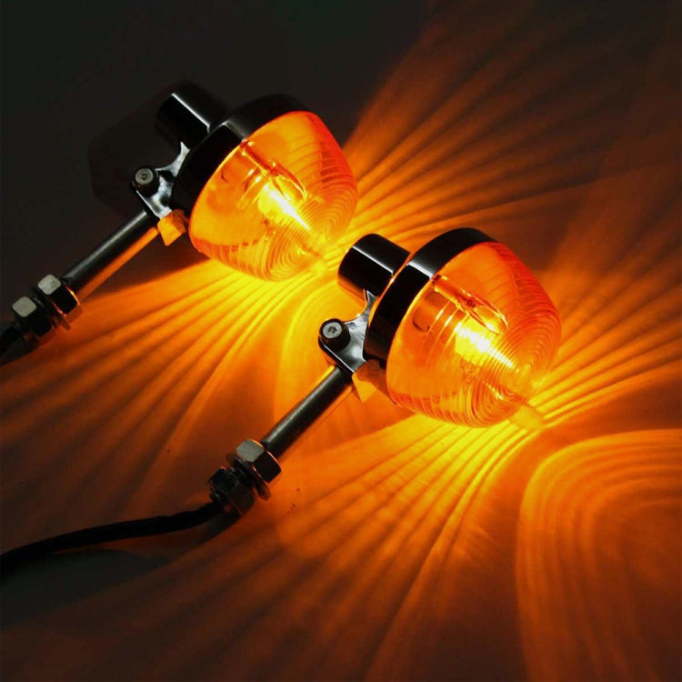 Two amber LED motorcycle turn signals glowing, chrome housings with front mounting arms