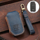 Leather key fob cover, blue with orange edge stitching and embossed emblem