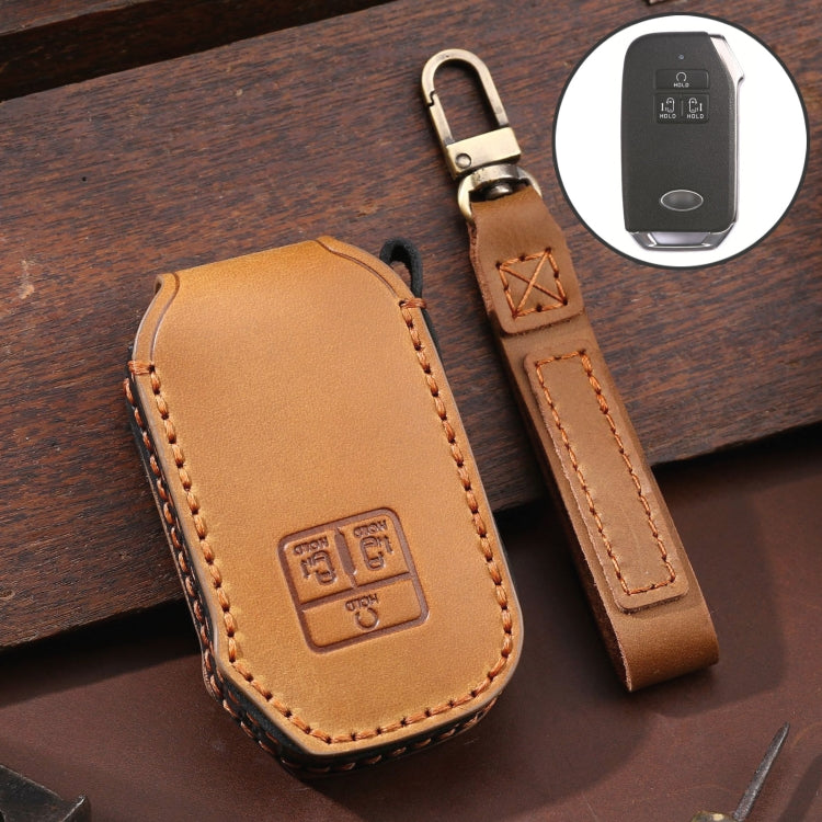 Leather key fob cover, tan/brown with orange edge stitching and embossed emblem