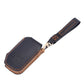 Leather key fob cover with wrist strap, dark color with orange contrast stitching