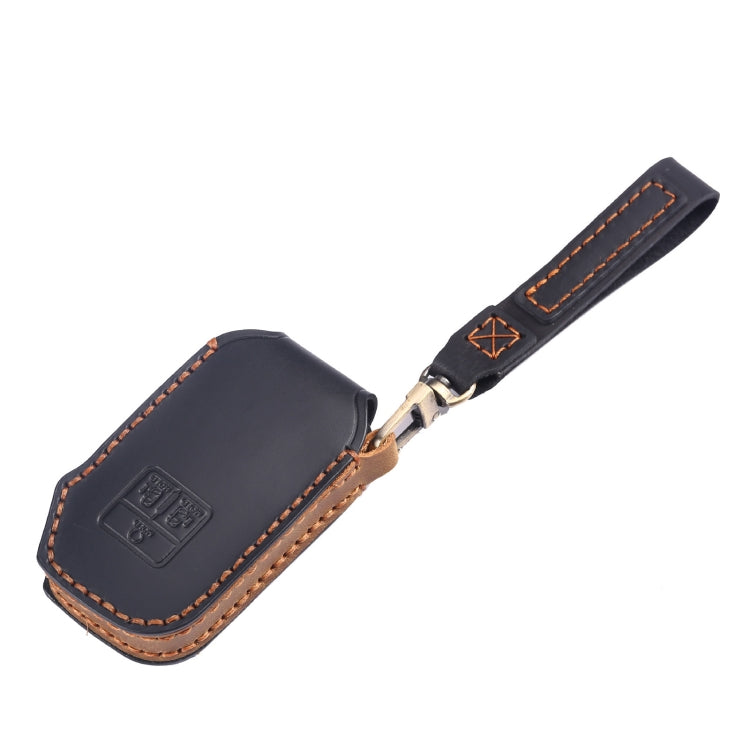 Leather key fob cover with wrist strap, dark color with orange contrast stitching