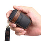 Black leather car key cover case held in hand with metal key ring and strap